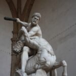 man fighting centaur statue