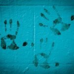 three hand prints on white wall